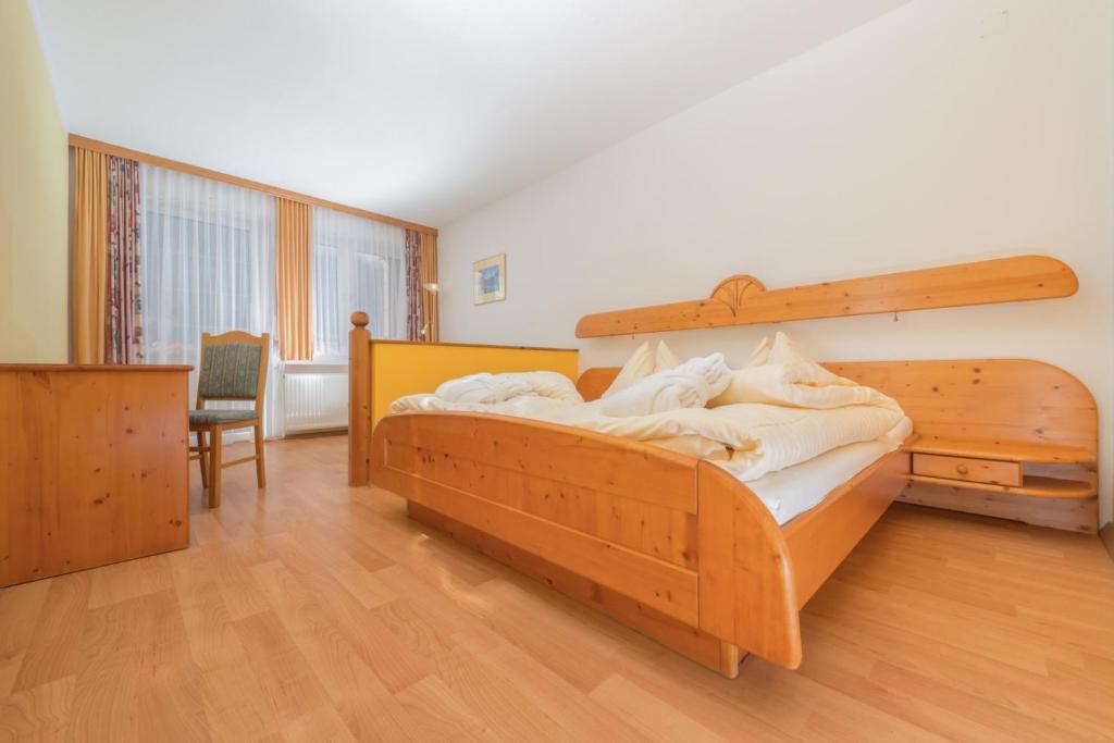 a bedroom with a large wooden bed in a room at Greiner's Ferienzimmer Tauplitz in Tauplitz