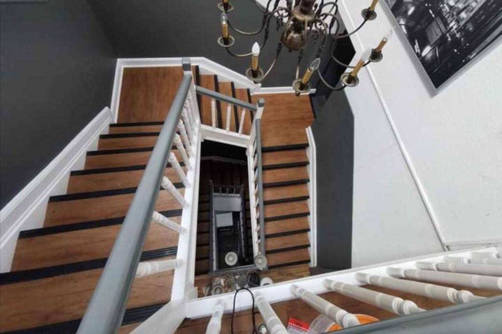 a staircase in a house with a chandelier at Eva's Hostel - Self Check-In & Room Just For You Alone in Düsseldorf
