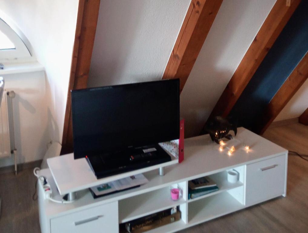 a white entertainment center with a flat screen tv on it at MeerMomente in Dorum Neufeld