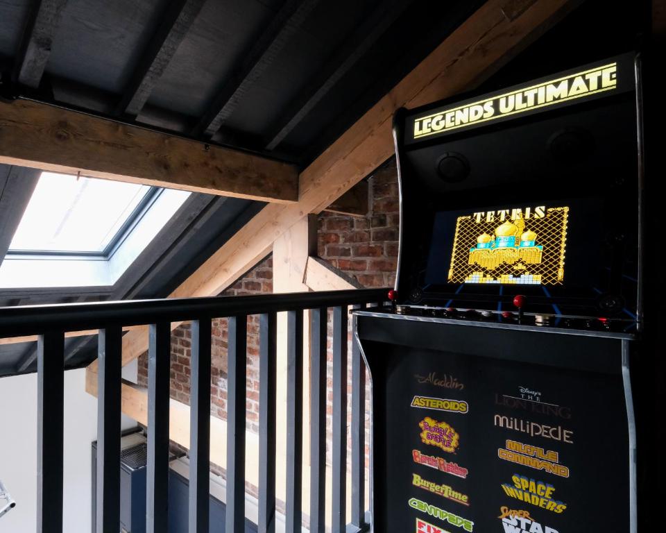 a video game machine sitting on top of a balcony at The Eden Warehouse - Green Apartment, sleeps 5 in Southport