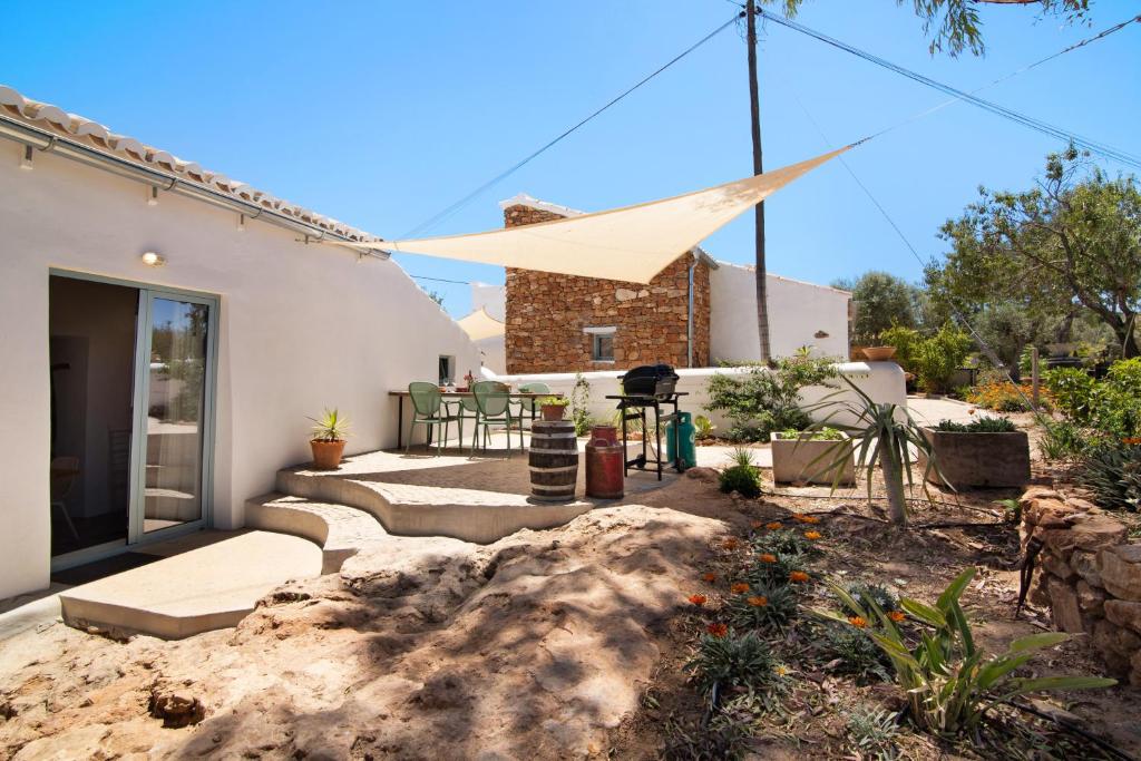 a house with a windmill on the front of it at Casa Burro in Moncarapacho