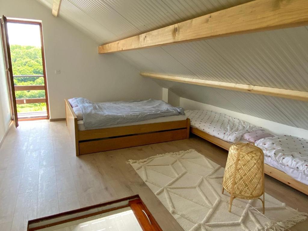 a bedroom with two bunk beds and a chair at Mrežnica - Zelena oaza I in Generalski Stol