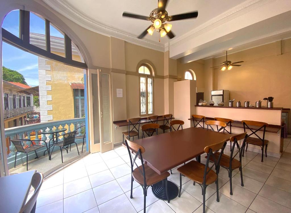 a dining room with a table and chairs on a balcony at Magnolia Inn in Panama City