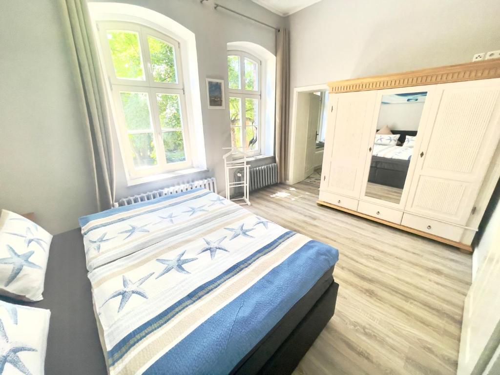 a bedroom with a bed and a large window at Gästehaus Sternschanze - App5 Leichtmatrose in Stralsund