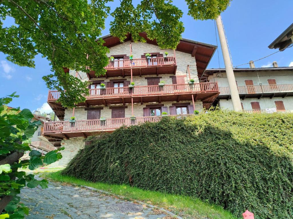 a building with a balcony on a hill at Appartamento Chatrian 1 CIR-TORGNON-0030 in Torgnon