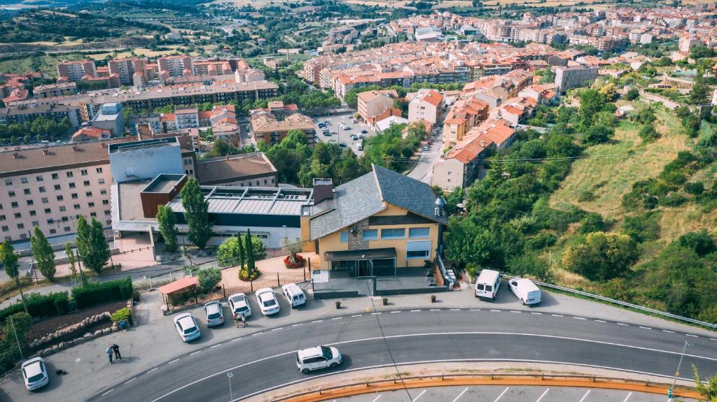 an aerial view of a city with cars on a road at HOTEL LA CABANA BERGA in Berga