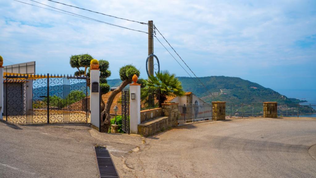 a gate with a view of the ocean at Castellabate Apartments Camere in Castellabate