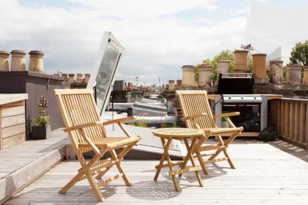 due sedie e un tavolo sul tetto di Sunny 2 bedroom, 2 bathroom Apartment with Roof Terrace a Londra