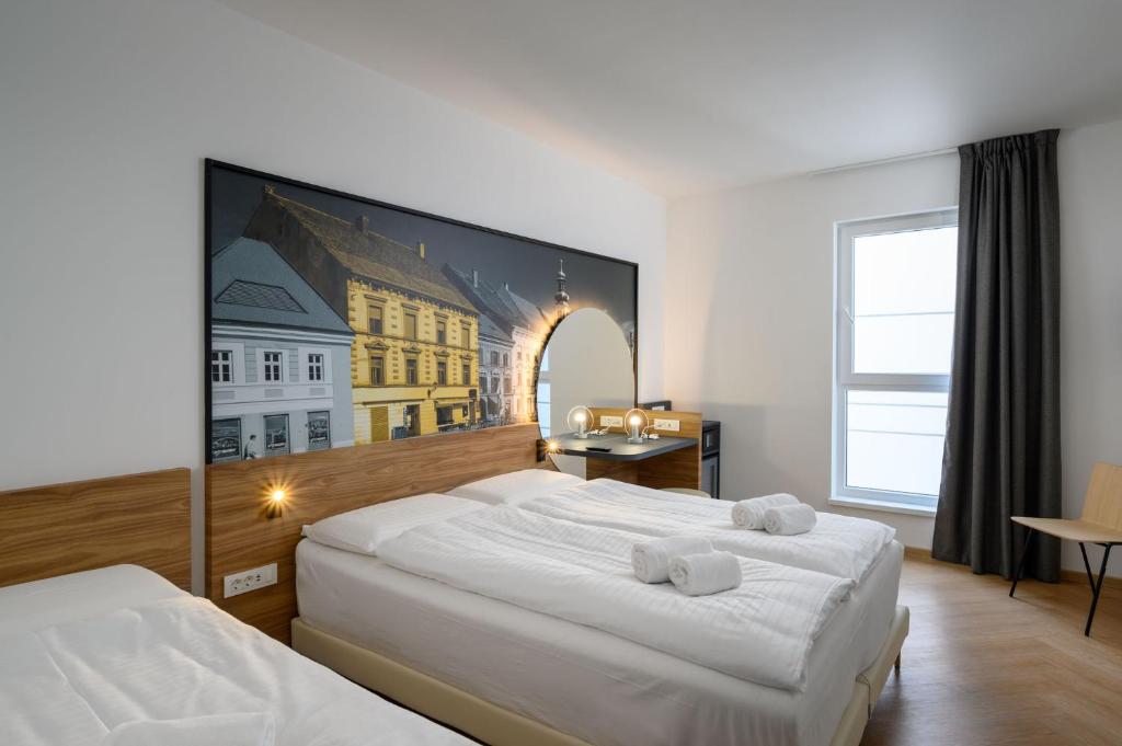 Postel nebo postele na pokoji v ubytování B&B Hotel Maribor
