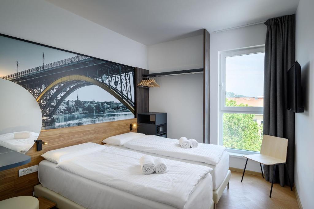 Postel nebo postele na pokoji v ubytování B&B Hotel Maribor