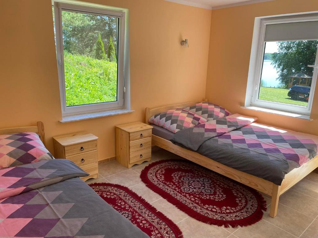 Posteľ alebo postele v izbe v ubytovaní Bajkowe Mazury Domek Wakacyjny