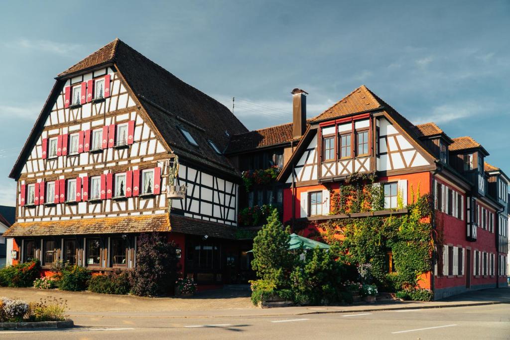 a large building with red and white at Hotel Krone in Beffendorf