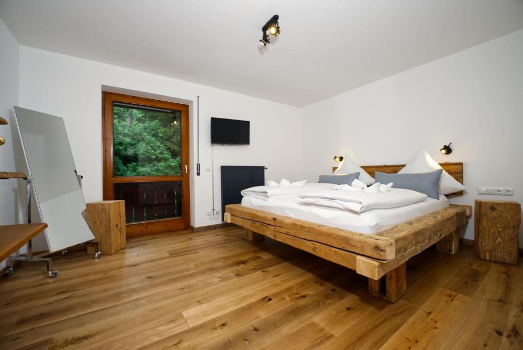 a bedroom with a large bed and a wooden floor at Ferienwohnung Schloßblick in Füssen