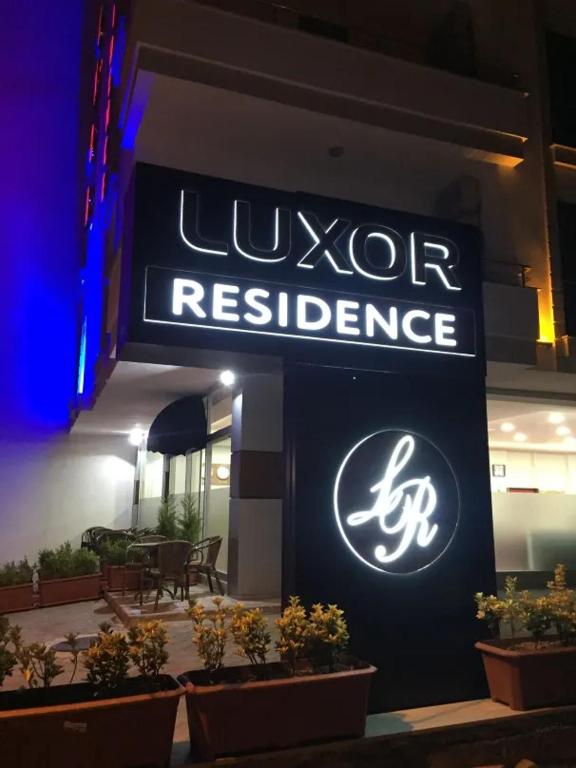 a sign for a liquor restaurant on the side of a building at LUXOR RESIDENCE in Trabzon