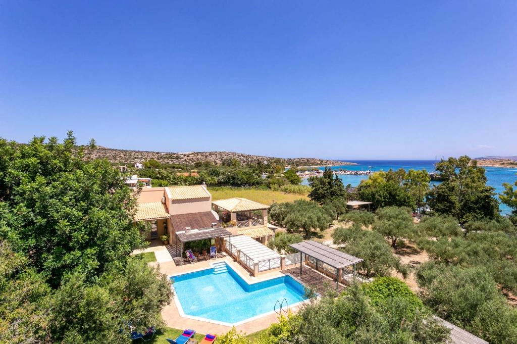 an aerial view of a house with a swimming pool at Villa Olive Grove by Villa Plus in Marathi