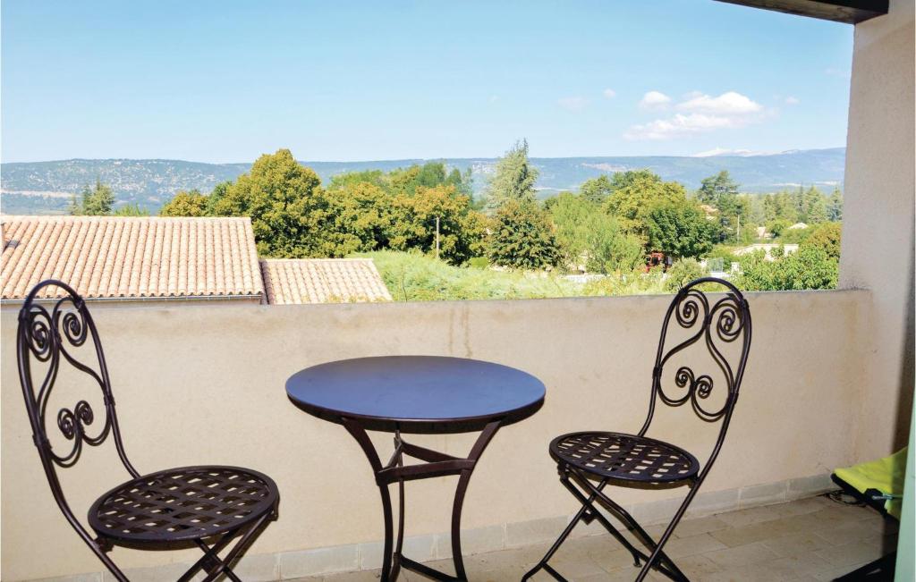 a table and two chairs on a balcony with a view at Gorgeous Apartment In Sault With Kitchenette in Sault-de-Vaucluse