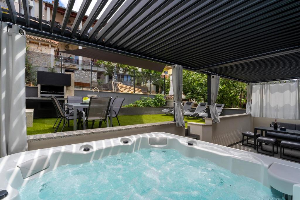 a hot tub on the roof of a house at Luxury family Apartment Rey in Vrsar