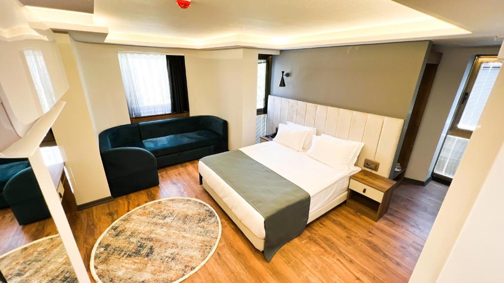 a hotel room with a bed and a couch at Nira Boutique Hotel in Ankara