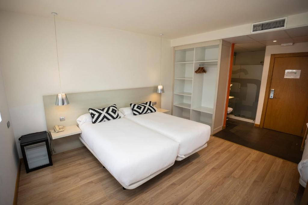 Postel nebo postele na pokoji v ubytování Hotel Restaurante Cadosa