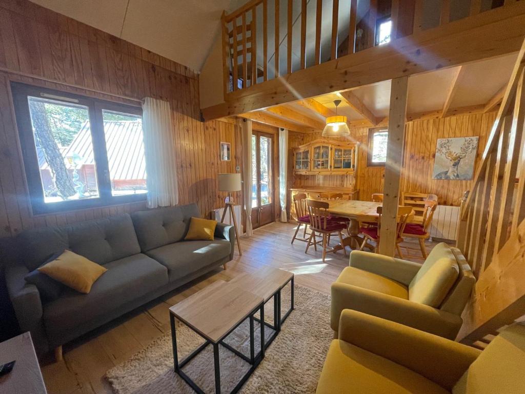 a living room with a couch and a table at Chalet Barcelonnette, 4 pièces, 8 personnes - FR-1-165A-121 in Barcelonnette