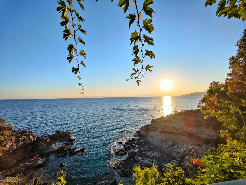 a view of the ocean at sunset from a cliff at Dimitra's Studios in Stoupa