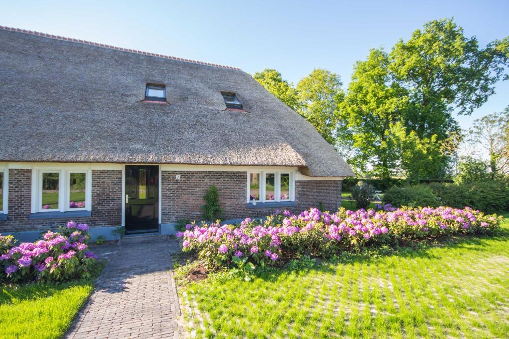 a house with pink flowers in front of it at Juffertje in het groen in Zwolle