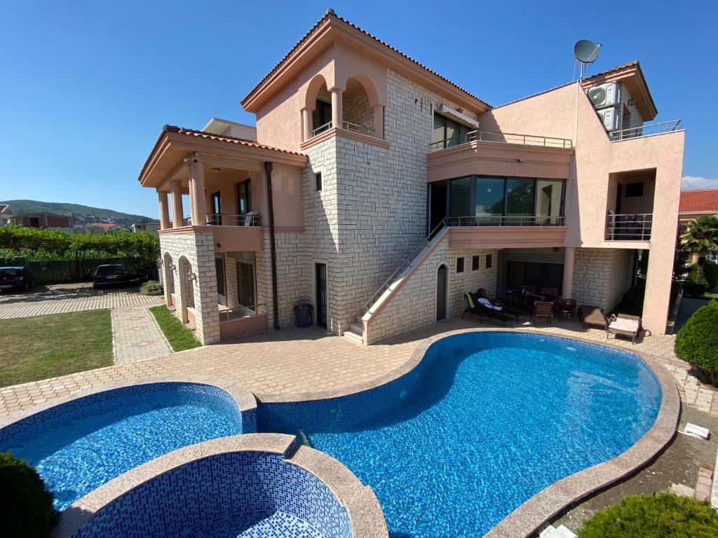 a house with a swimming pool in front of it at Luxury Villa Ulcinj in Ulcinj