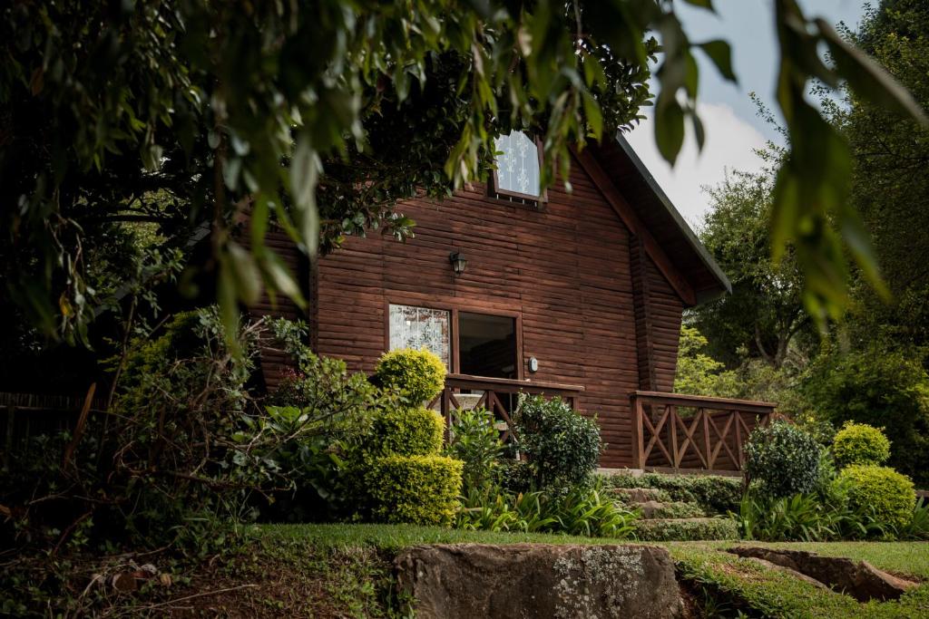 a log cabin with a staircase leading up to it at Viewpoint - Cabin 2 in Haenertsburg