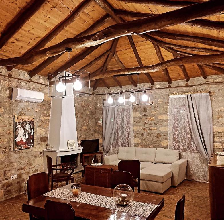 een woonkamer met een bank en een tafel bij Το Πατρικό - To Patriko Epidavros in Oud Epidauros