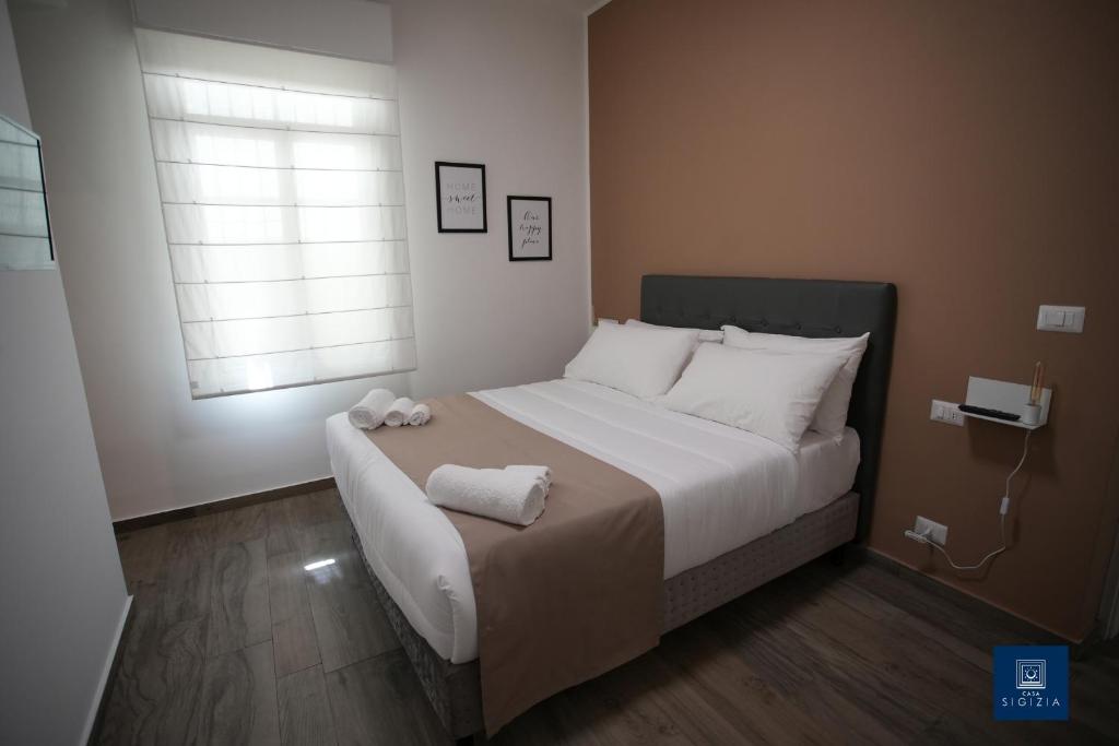 Postel nebo postele na pokoji v ubytování Casa Sigizia