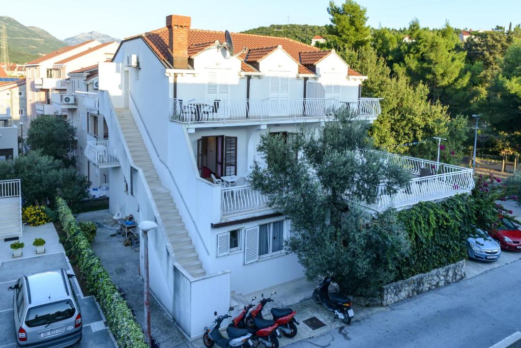 an aerial view of a white building with motorcycles parked outside at Villa Adria in Cavtat