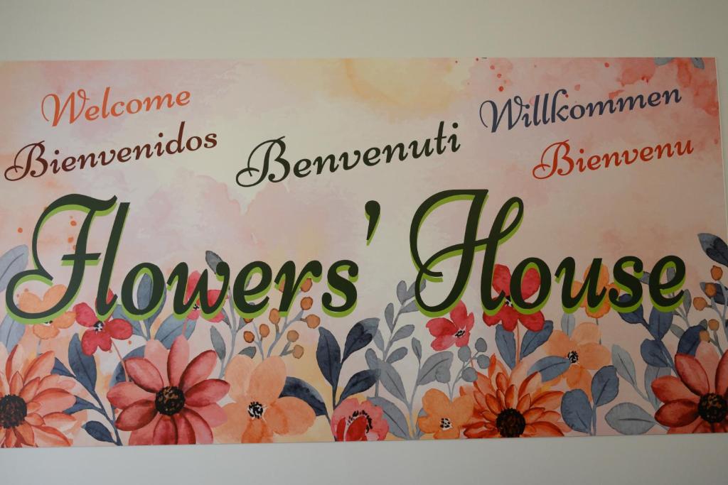 a sign for a flowers house on a wall at Flowers' House in Castellammare di Stabia