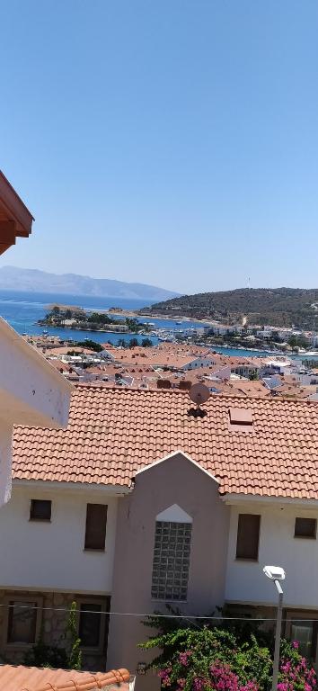 a white building with a red roof and a beach at Triplex house, near center and sea in Datca