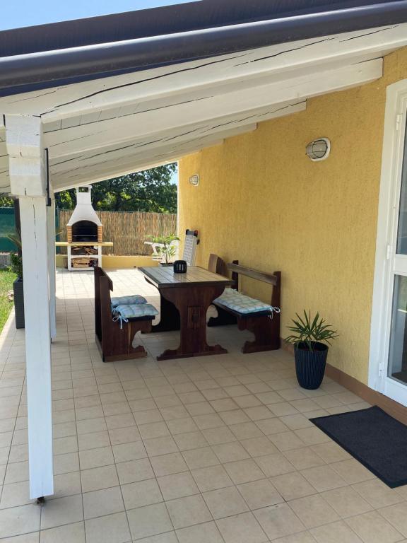 a patio with a table and chairs on it at Holiday Home Rosa in Gedići