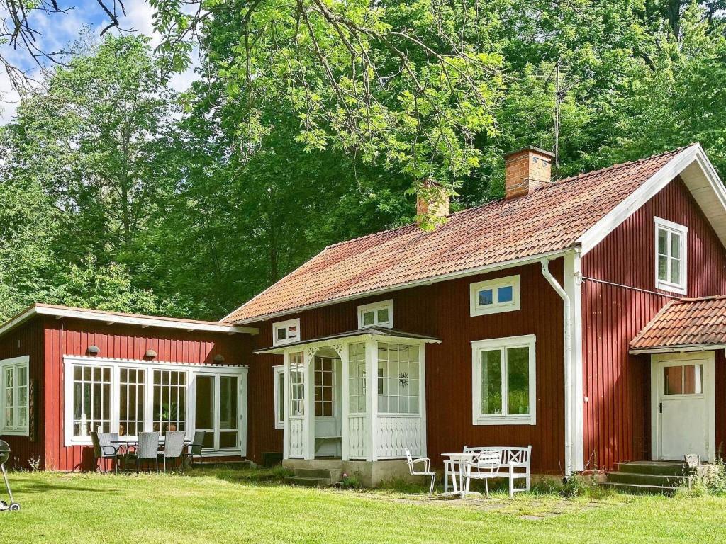 une maison rouge avec une table devant elle dans l'établissement 6 person holiday home in VERUM, à Överum