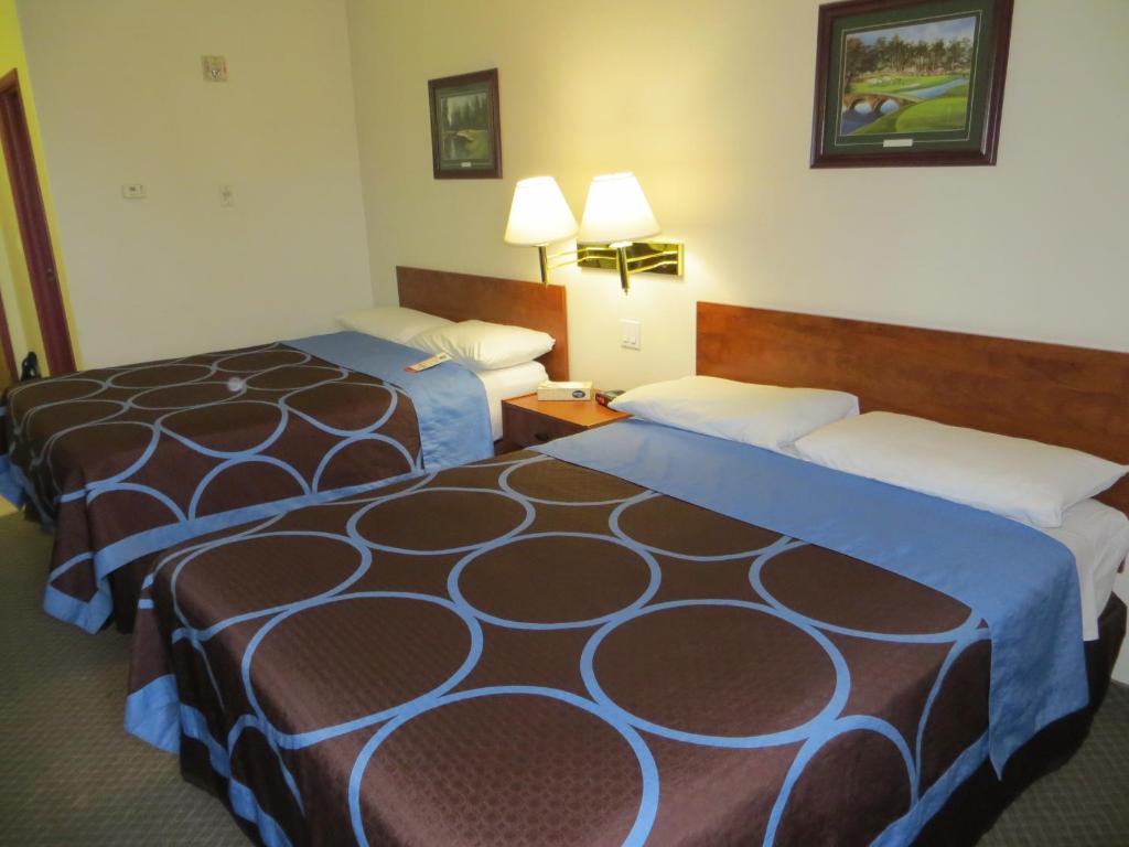 a hotel room with two beds and two lamps at Super 8 by Wyndham Edmonton/West in Edmonton