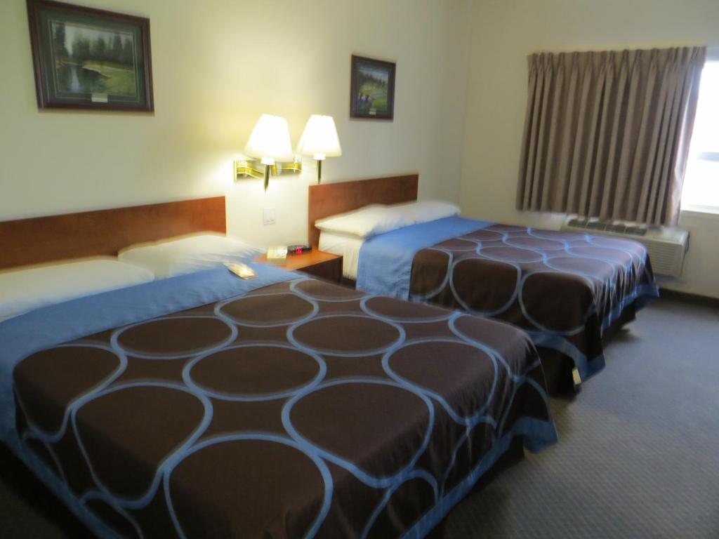 a hotel room with two beds and a window at Super 8 by Wyndham Edmonton/West in Edmonton