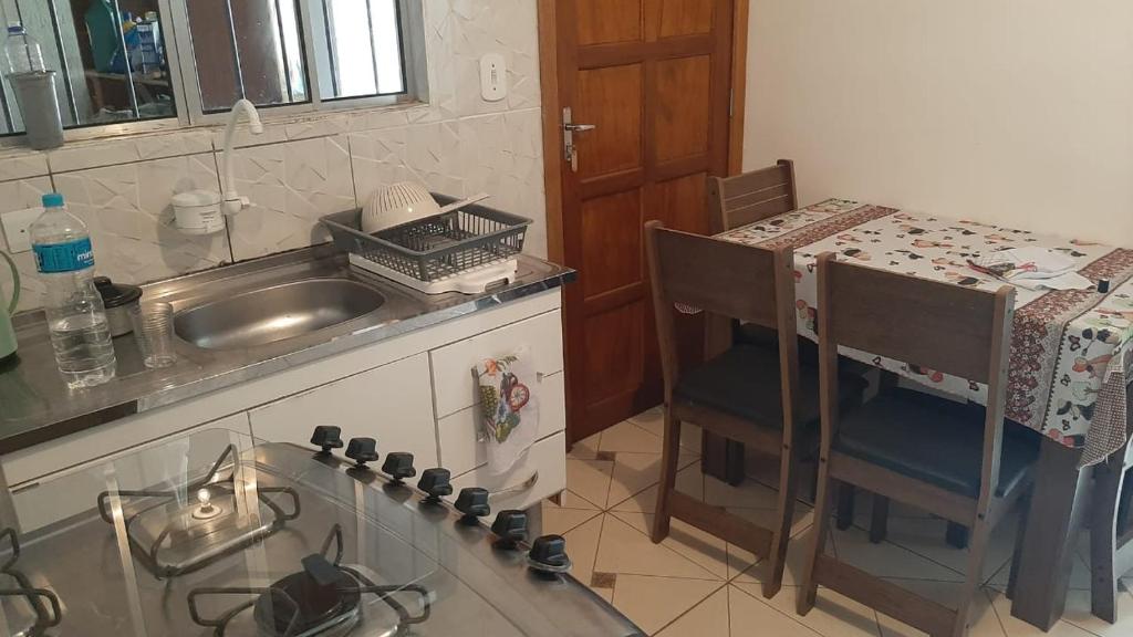 a kitchen with a sink and a counter top at Cantinho do Nono 3 in Campos do Jordão