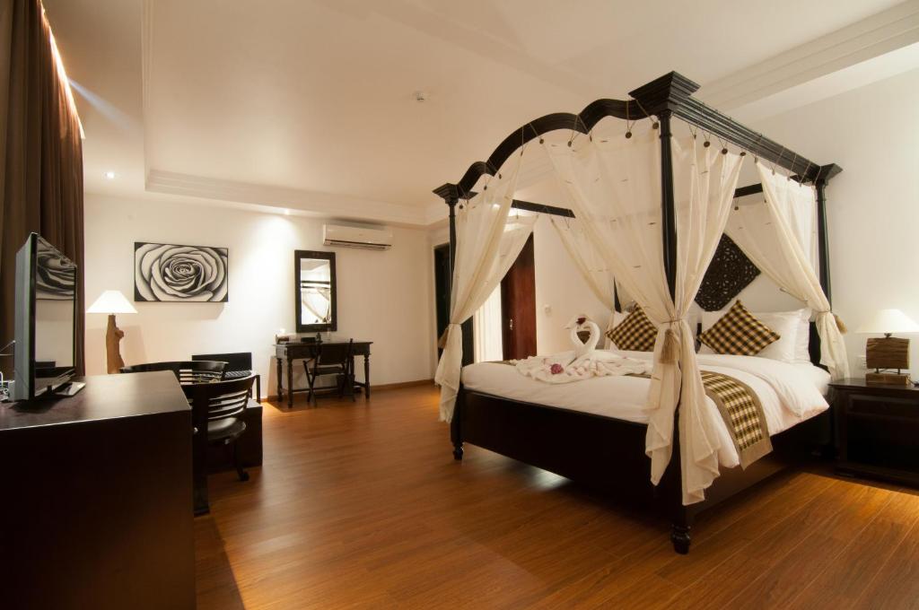 Postel nebo postele na pokoji v ubytování La Rose Suites
