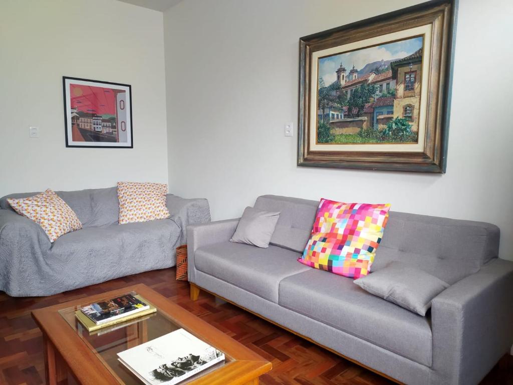 a living room with two couches and a coffee table at Casa Vermelha in Ouro Preto