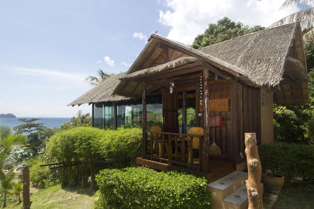 a small house with a view of the ocean at Glass Cottage in Wok Tum