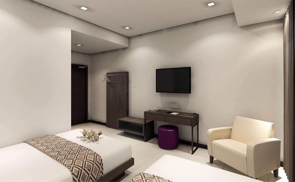 Postel nebo postele na pokoji v ubytování Beryll Inn Cyberjaya Hotel