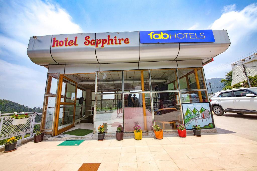 a hotel sapphire building with potted plants in front of it at FabExpress Sapphire in Mussoorie