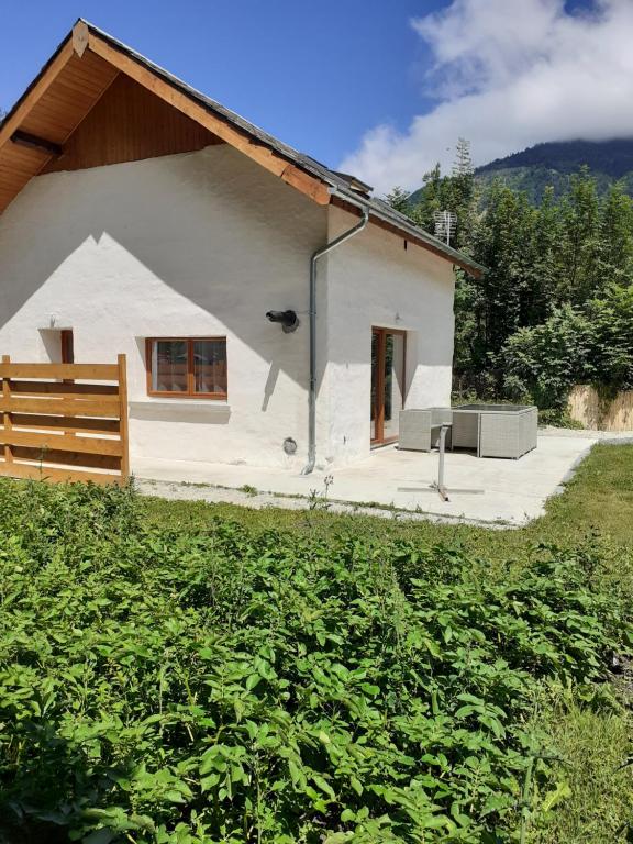 une petite maison blanche avec une clôture devant elle dans l'établissement Petite maison bien vivre au coeur de la montagne, à Grandes Sables