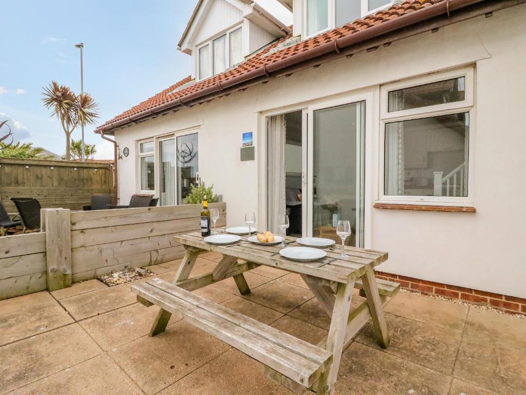 a picnic table on the patio of a house at Seaview in Weymouth