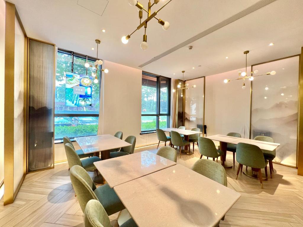 a restaurant with tables and chairs and a large window at Sincere Residence Changfeng - Changfeng Ecological Business District - Near Exit 3 of Changfeng Park Station on Subway Line 15 in Shanghai