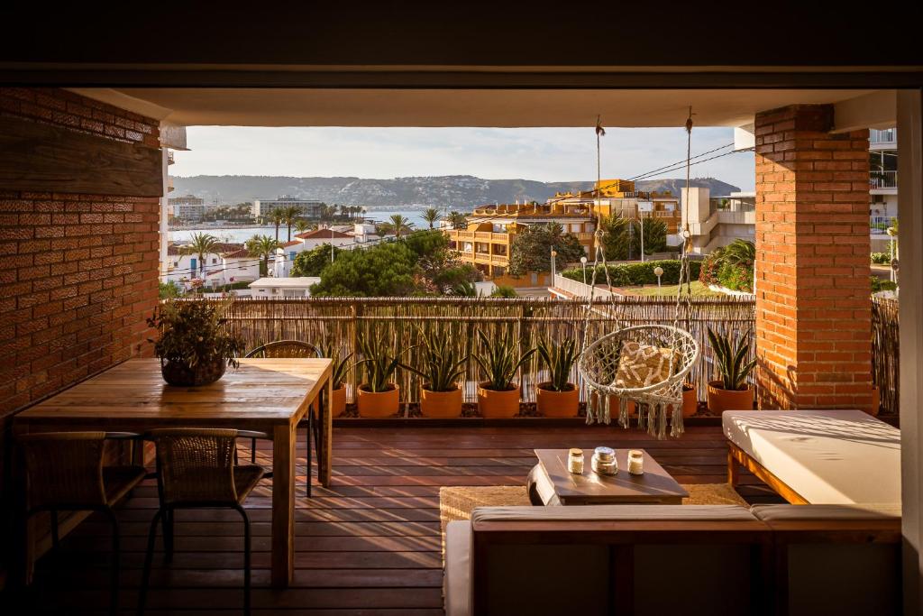 a balcony with a table and a view of a city at K-TERRA by Nuka Homes in Jávea