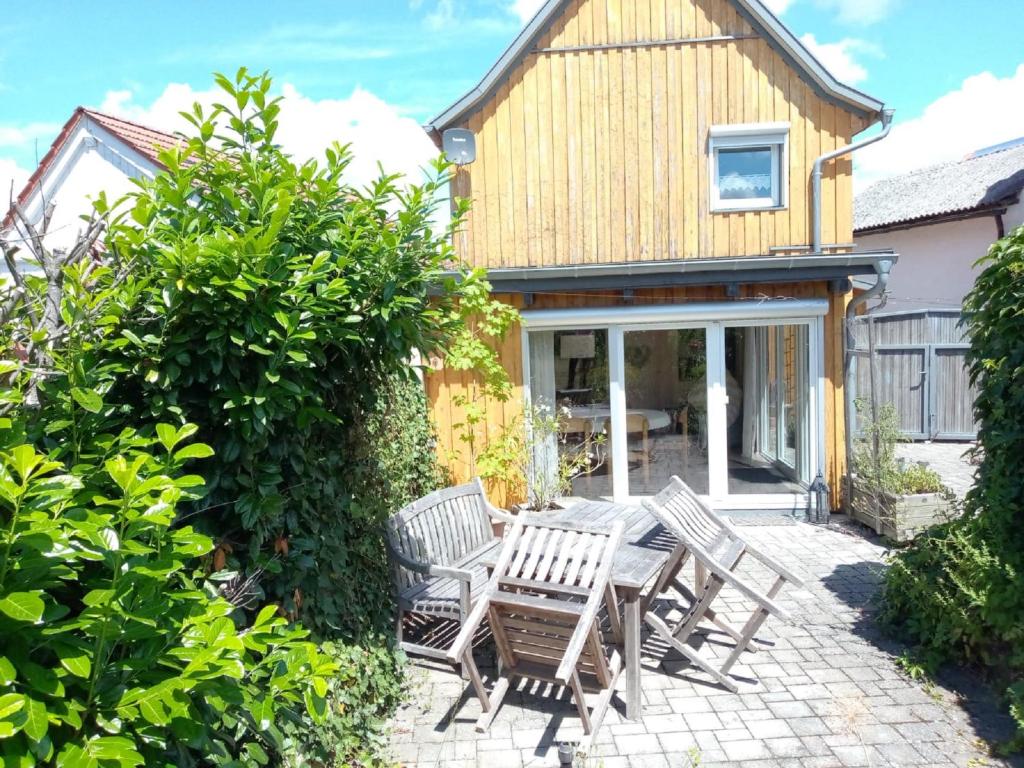 a patio with chairs and a table in front of a house at Ferienhaus Silvia 