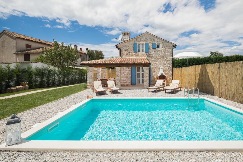 a pool in the backyard of a house at Villa Ivea in Višnjan