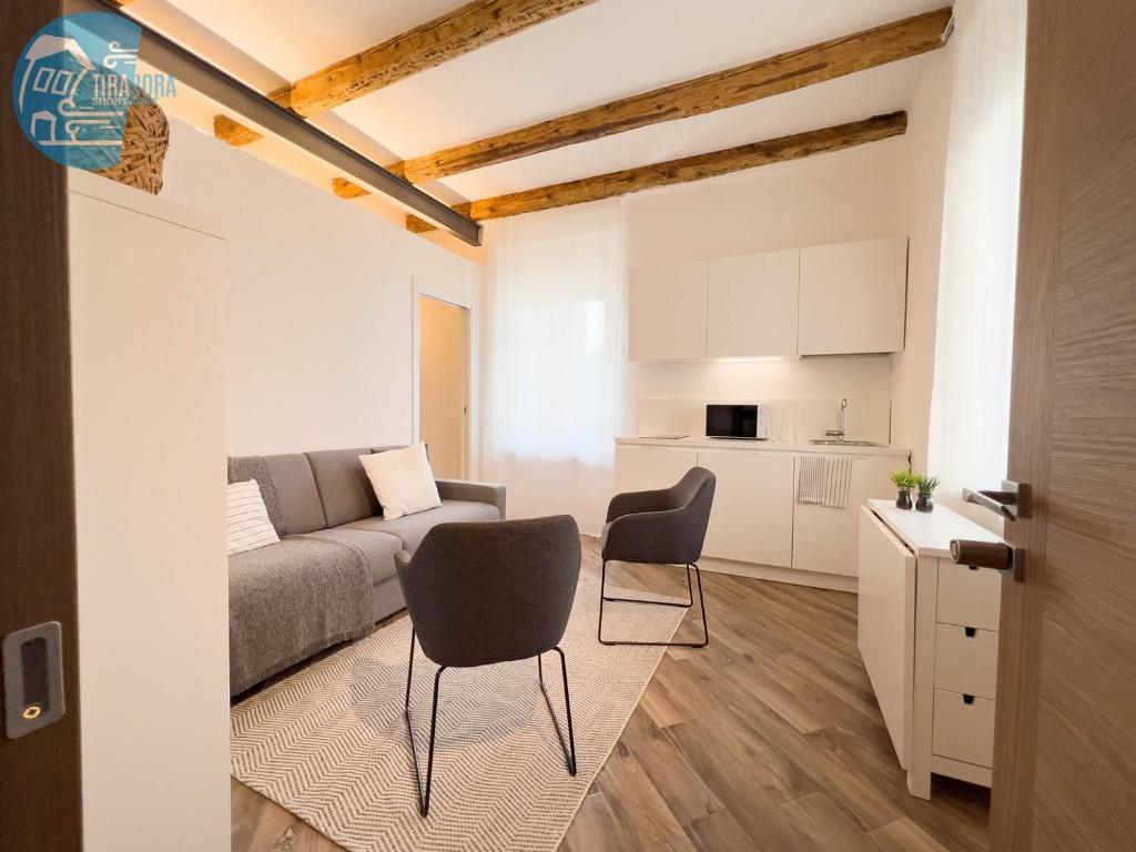 a living room with a couch and a table and chairs at Basovizza 3 Alessandro Tirabora Short Rent in Villa Opicina